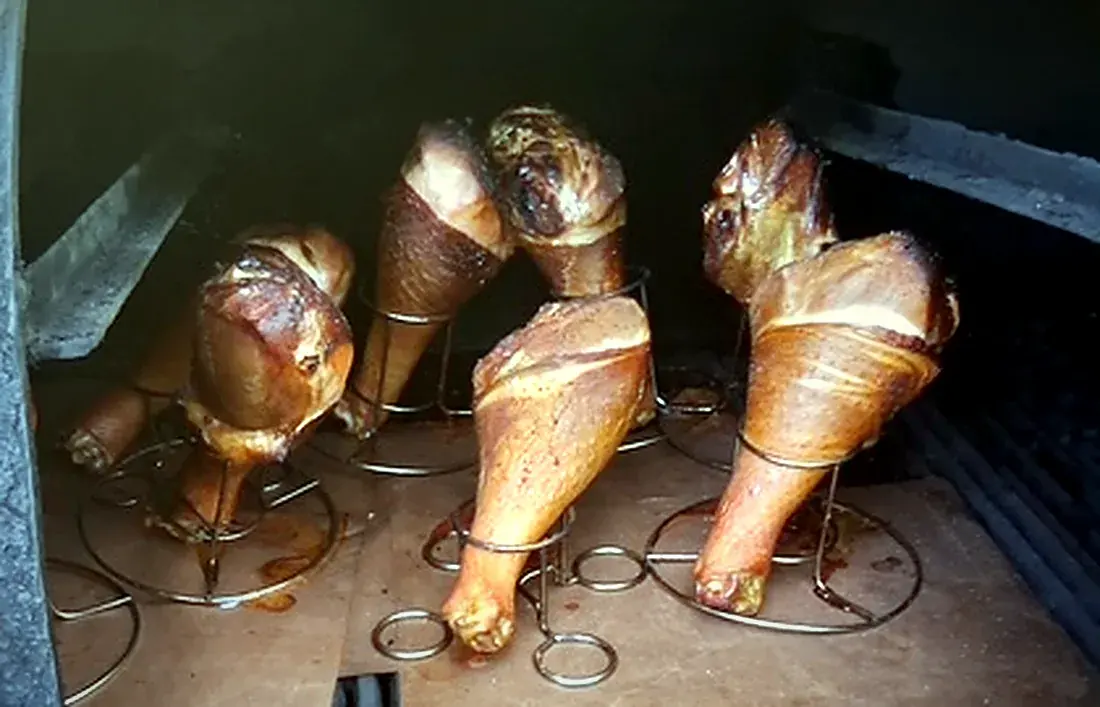 Turkey legs on racks taking on smoke